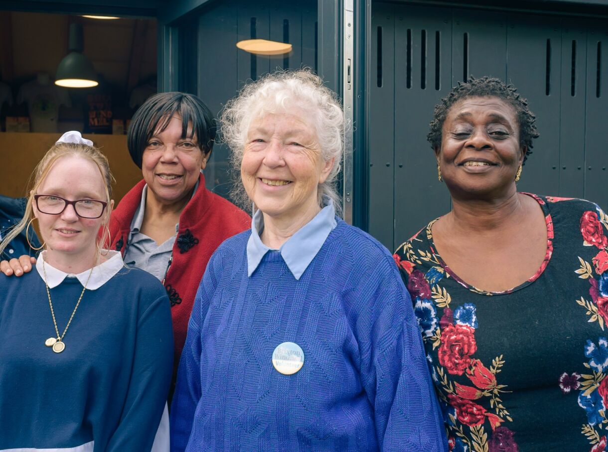 A group of female volunteers standing outside the Brixton Windmill Community Centre
